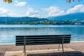 Lonely bench at waterfront of lake Lucerne in Luzern, Switzerlan Royalty Free Stock Photo