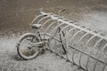 A lonely bicycle covered with fresh snow due to weather phenomena - snowfall in late April near Moscow