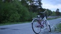 Lonely bike on an empty road near the forest Royalty Free Stock Photo