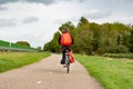 A lonely biker with a backpack near the A44 highway in the south-Holland village of Sassenheim Royalty Free Stock Photo