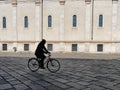 Lonely biker silhouette in urban walkway downtown