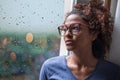 Lonely black woman near window thinking about something Royalty Free Stock Photo