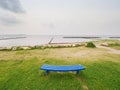 The lonely blue bench on an empty beach near sea Royalty Free Stock Photo