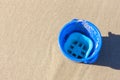 A lonely blue bucket at the beach