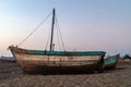 A lonely boat on the beach, sand. late time of the day