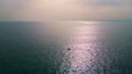 Lonely boat floating endless ocean aerial view. Bright sunlight reflecting water Royalty Free Stock Photo