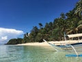 A lonely boat on the paradise sandy beach,with palm trees, Palawan, Philippines