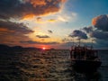 Lonely boat sailing to the horizon at sunset on the mediterranean sea Royalty Free Stock Photo