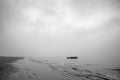 A lonely boat with sailor preparing for early morning sail into uncertainty