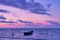 Lonely boat on the sea, sunrise shot, purple sky