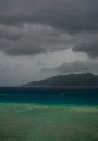 Lonely boat in the storm. Coast line and black clouds in the background