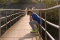 Lonely boy sitting on a suspension bridge Royalty Free Stock Photo