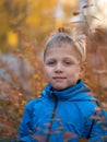 Lonely boy with a smile in autumn Park