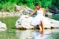 Lonely bride in a rock by the river Royalty Free Stock Photo