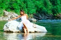 Lonely bride in a rock by the river Royalty Free Stock Photo