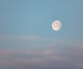 Lonely bright moon in the morning cloudy blue sky