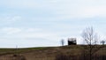 Lonely building with small dry trees against the sky. Royalty Free Stock Photo