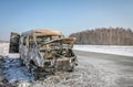 Lonely burnt car on a suburban highway