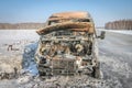 Lonely burnt car on a suburban highway