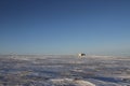 Lonely cabin along an arctic landscape with snow on the ground