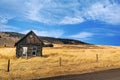 Lonely Cabin surrounded by golden fields. Royalty Free Stock Photo