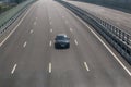 lonely car driving on a multi-lane highway Royalty Free Stock Photo
