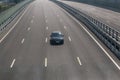 lonely car driving on a multi-lane highway