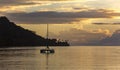 Lonely catamaran at sunset near Bora-Bora island Royalty Free Stock Photo