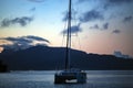 Lonely catamaran against the background a golden sunset near Bora-Bora island Royalty Free Stock Photo