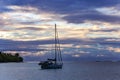 Lonely catamaran at sunset near Tahaa island Royalty Free Stock Photo