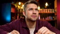 Lonely caucasian man spending time watching news on tv in bar, evening leisure Royalty Free Stock Photo