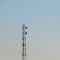 A lonely cell tower on the background of the dirty blue of the sky Royalty Free Stock Photo