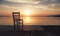 A lonely chair on the sea at sunset