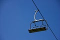 Lonely chairlift on blue sky Royalty Free Stock Photo