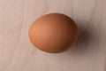Lonely chicken egg on a wooden background Royalty Free Stock Photo