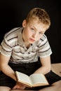 Lonely child sitting and reading a book Royalty Free Stock Photo