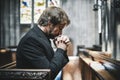 Lonely Christian man praying in the church Royalty Free Stock Photo