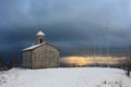 Lonely church in romantic snowy and frozen landscape on top of the mountain in winter Royalty Free Stock Photo