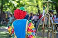 Lonely clown in colorful costume in front of people