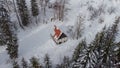 Lonely cottage or house in the middle of the snowy enchanted forest. Old cozy cabin in a forest covered with snow, viewed from Royalty Free Stock Photo