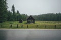 A lonely cottage in the misty and foggy forest just after the storm. Photograph was taken at Corvara in Dolomites mountain range, Royalty Free Stock Photo