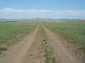 A lonely country road in the vast steppe of Arkhangai, Mongolia.