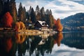 Lonely cozy house near a lake in a autumn forest, against the background of mountains Royalty Free Stock Photo