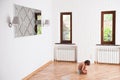 Lonely cute boy sits on the floor in bright room Royalty Free Stock Photo