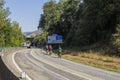 A lonely cyclist biking in an empty spanish road in the summer