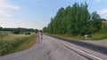A lonely cyclist on a long Swedish road