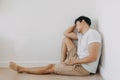 Lonely depressed man sit at the corner of the room. Royalty Free Stock Photo