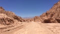 Lonely desert road winding through large rocks, near San Pedro de Atacama, Chile Royalty Free Stock Photo