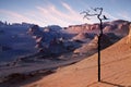 Lonely dry tree and bird in the desert against a beautiful pink sky and clouds. Artistic natural image. Alien Planet Concept.