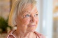 Lonely elderly woman standing reminiscing Royalty Free Stock Photo
